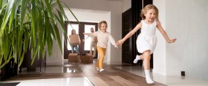 First Home Buyers -Kids running into new house parents